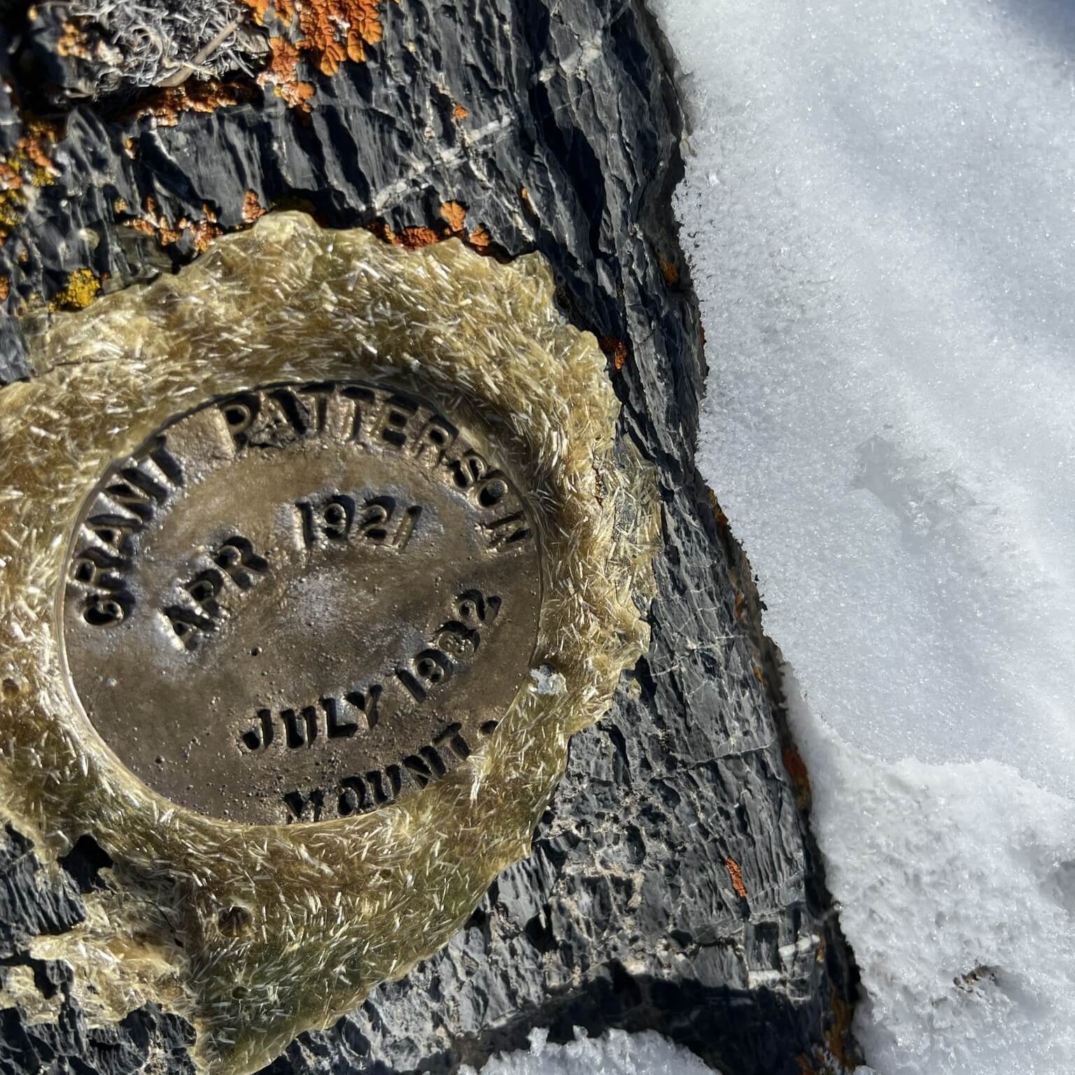 old-brass-survey-cap-in-rock-snow-idaho-galena-benchmark-engineering